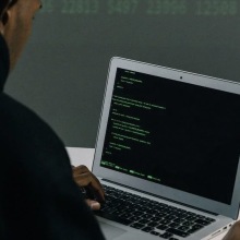 Person coding on a laptop.
